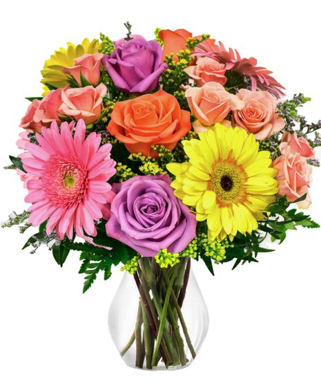 A colorful vase arrangement of gerbera daisies and roses.