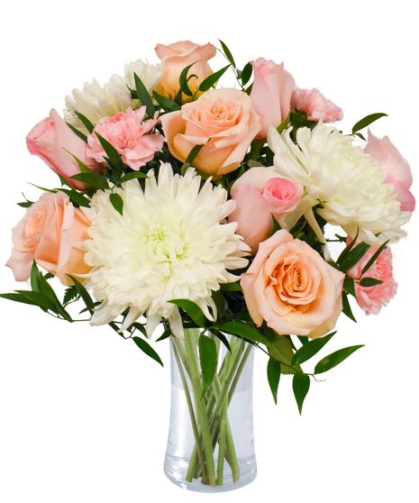 soft peach roses, pink carnations, and white mums in a clear glass vase